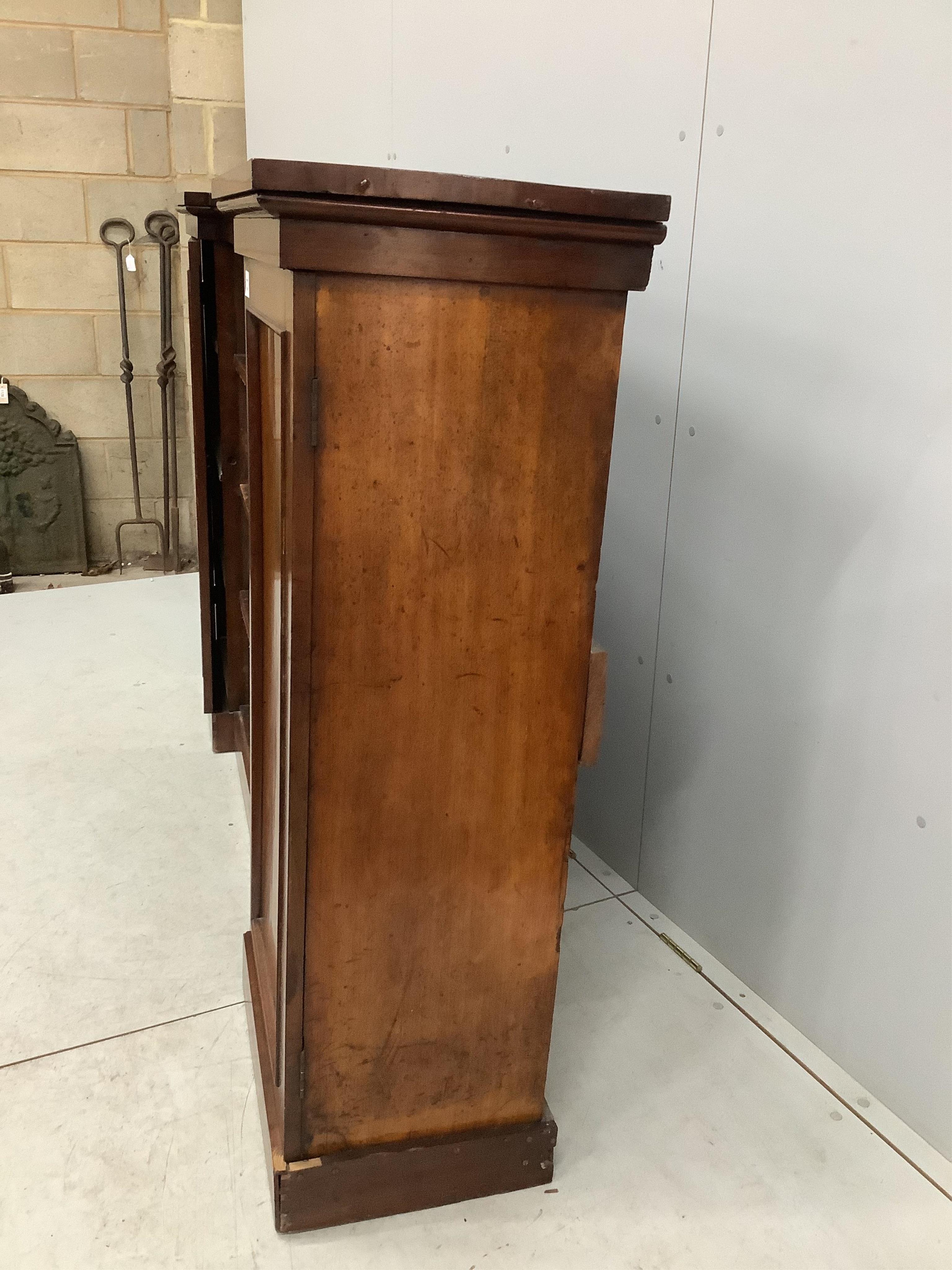 A Victorian mahogany inverted breakfront bookcase cupboard, width 198cm, depth 39cm, height 124cm. Condition - fair, one plinth foot corner split with lost veneer